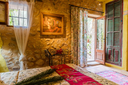 Finca Can Duvai_Superior_Garten_Apartment_Roteszimmer_Bett2.webp